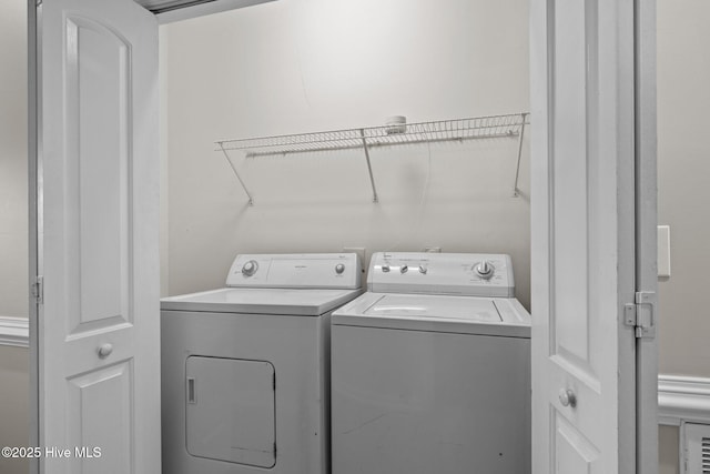 clothes washing area with washer and dryer