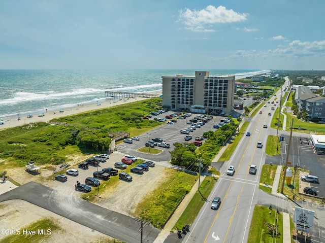 birds eye view of property with a water view and a view of the beach