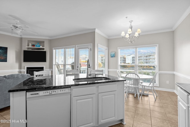 kitchen featuring sink, built in features, dishwasher, white cabinetry, and light tile patterned flooring