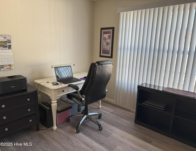 home office with light hardwood / wood-style floors