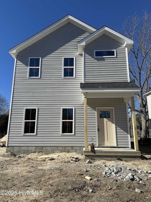 back of property with a porch