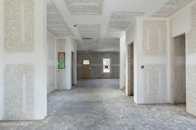 hallway with concrete floors