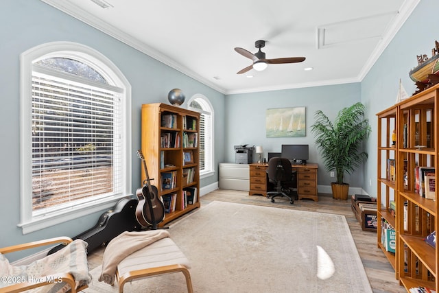 office space featuring ceiling fan, ornamental molding, and light hardwood / wood-style flooring