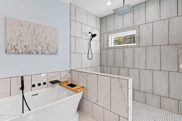 bathroom featuring shower with separate bathtub and tile walls