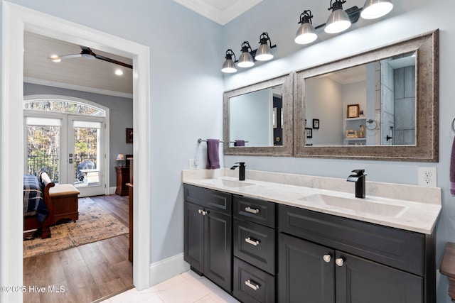 bathroom with hardwood / wood-style flooring, ornamental molding, vanity, and french doors