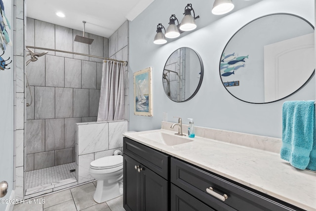 bathroom with vanity, curtained shower, tile patterned floors, and toilet