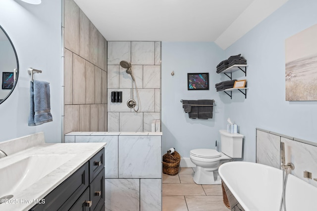 bathroom featuring a tub to relax in, vanity, and toilet