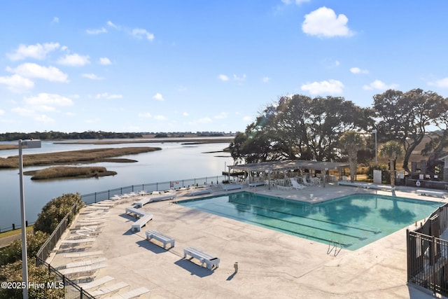 view of swimming pool featuring a patio and a water view