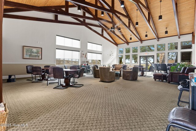 interior space with high vaulted ceiling, carpet flooring, wood ceiling, beam ceiling, and french doors