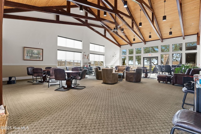 sunroom featuring lofted ceiling with beams