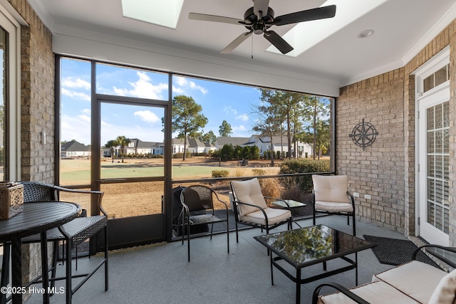 sunroom featuring ceiling fan and a healthy amount of sunlight