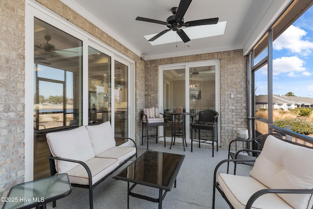 sunroom featuring ceiling fan