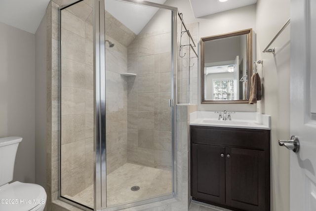 bathroom with toilet, a shower with door, lofted ceiling, and vanity