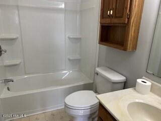 full bathroom featuring vanity,  shower combination, and toilet