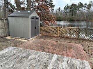 exterior space with a water view and a storage unit