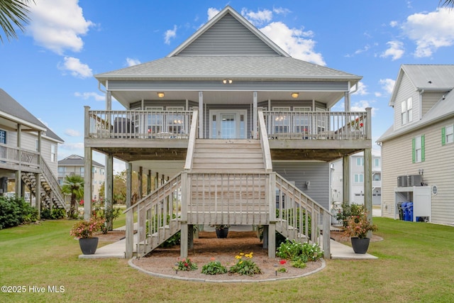 rear view of house featuring a yard and a porch