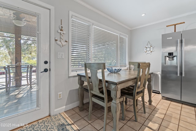 tiled dining space featuring ornamental molding