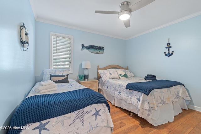 bedroom with ceiling fan, ornamental molding, and light wood-type flooring