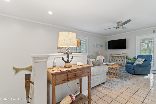 living room featuring crown molding, ceiling fan, and light tile patterned flooring