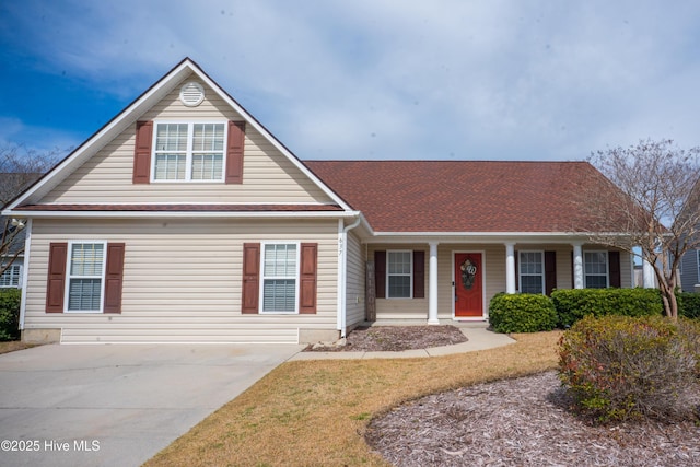 traditional home featuring a porch and driveway