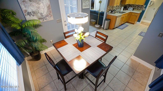 dining room with light tile patterned floors and baseboards