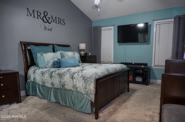 carpeted bedroom featuring lofted ceiling, ceiling fan, and baseboards