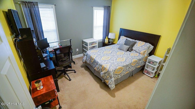 carpeted bedroom featuring baseboards