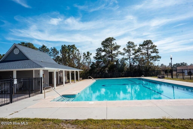 community pool featuring a patio and fence