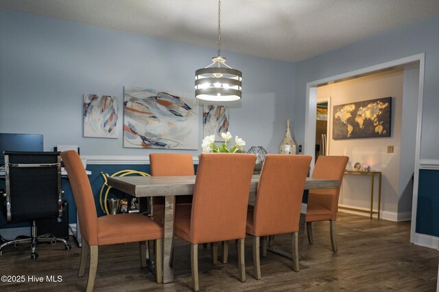 dining area featuring baseboards and wood finished floors