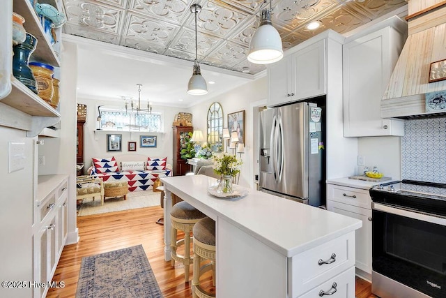 kitchen featuring electric range oven, white cabinets, custom exhaust hood, stainless steel refrigerator with ice dispenser, and light wood-type flooring