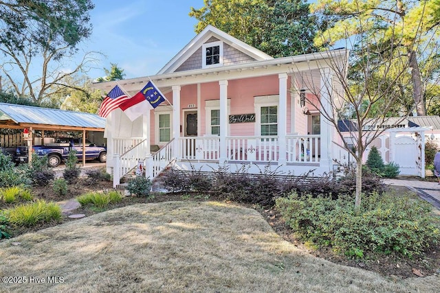 view of front facade featuring a porch and a carport