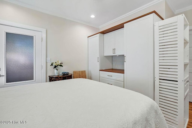 bedroom featuring crown molding and a closet