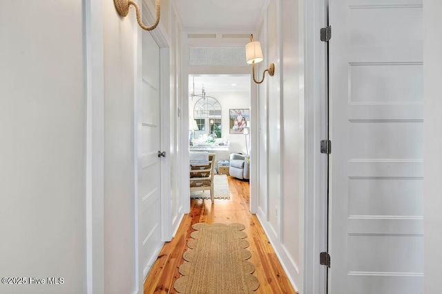 hallway with light hardwood / wood-style floors