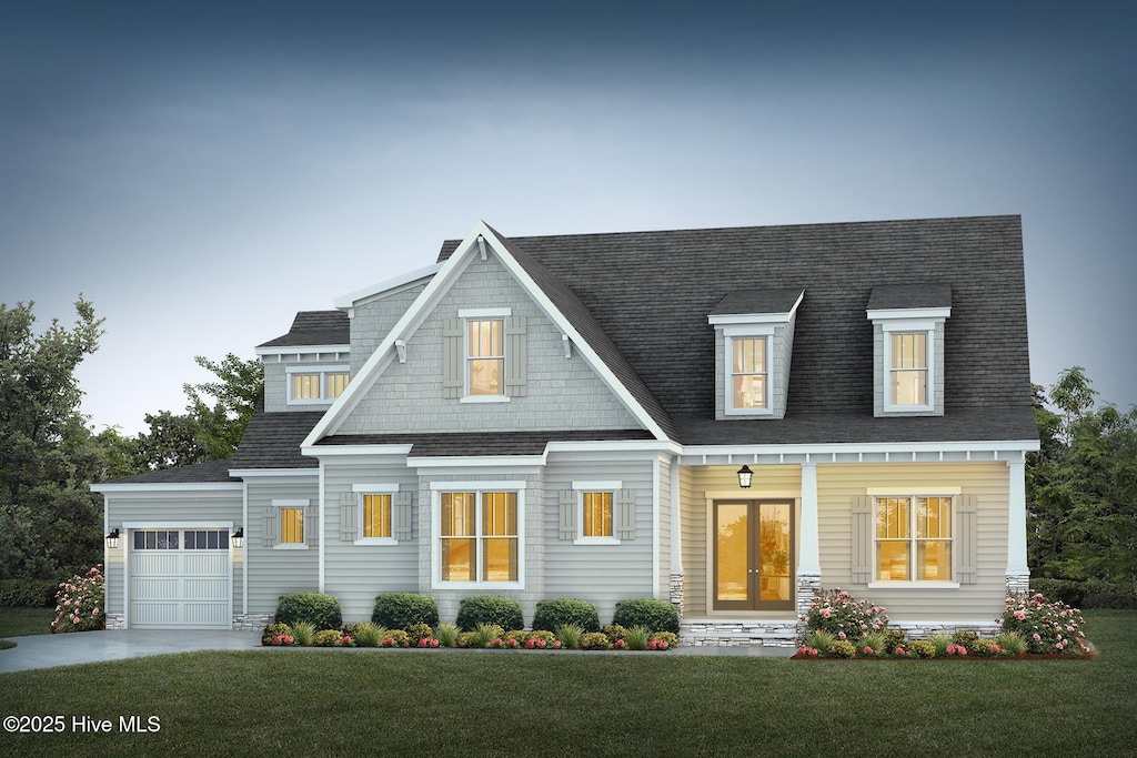 view of front of property with a garage and a front yard