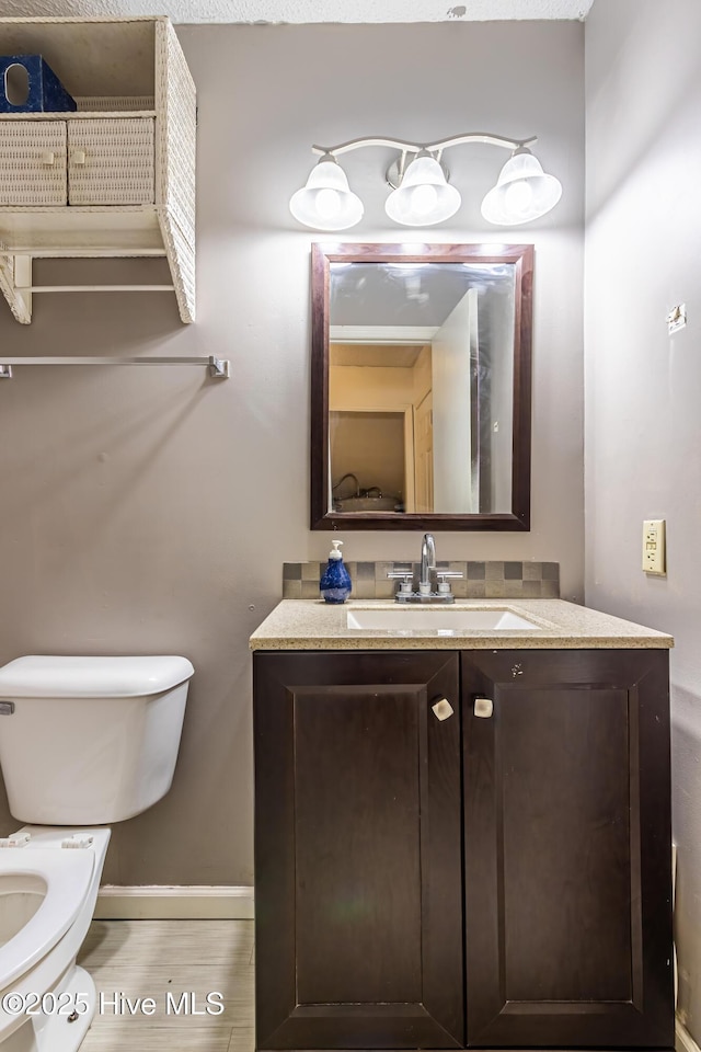 bathroom featuring toilet and vanity