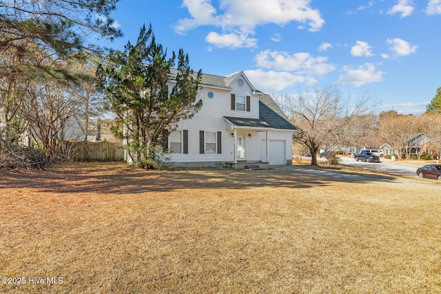 view of side of property with a garage and a yard