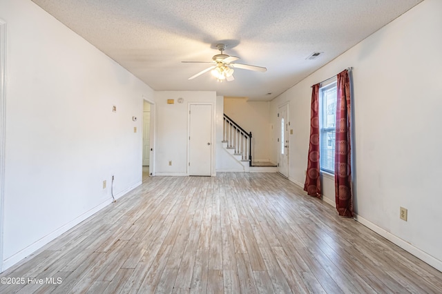 spare room featuring ceiling fan, a textured ceiling, and light hardwood / wood-style floors