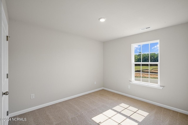 empty room featuring light carpet