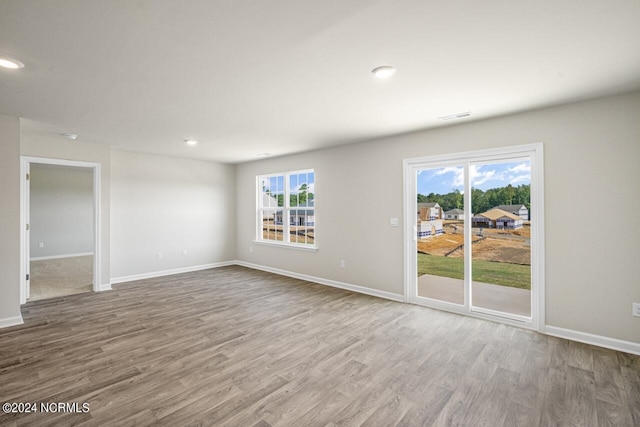 empty room with hardwood / wood-style flooring