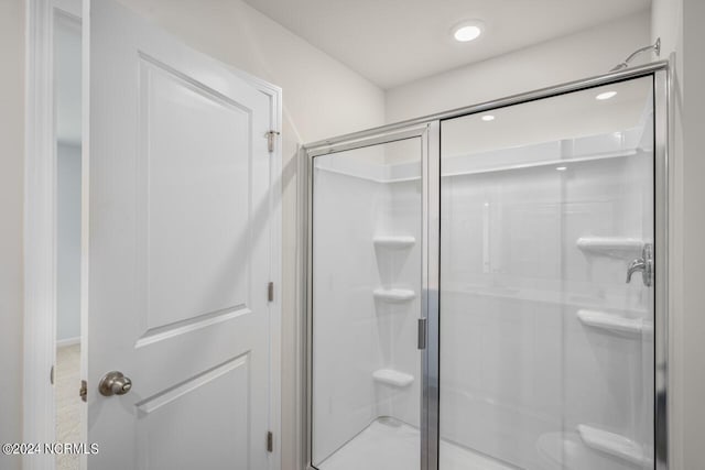 bathroom featuring a shower with shower door