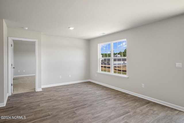 spare room with hardwood / wood-style flooring