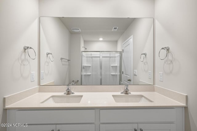 bathroom featuring walk in shower and vanity