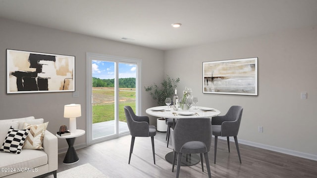 dining space with wood-type flooring