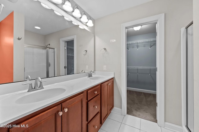 bathroom with tile patterned floors, vanity, and an enclosed shower