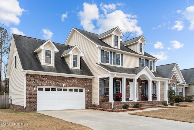 cape cod-style house featuring covered porch and a garage