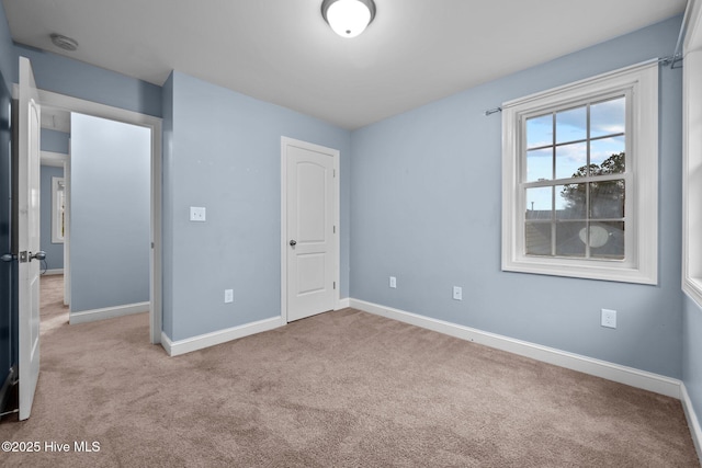 unfurnished bedroom featuring light carpet