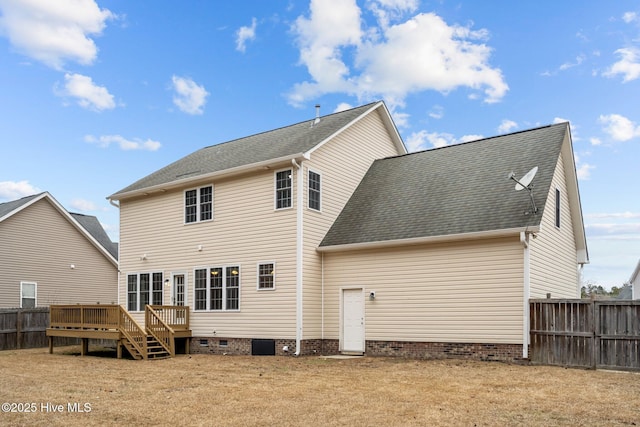 rear view of house featuring a yard and a deck