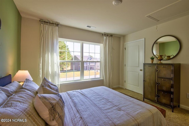 bedroom with carpet and multiple windows