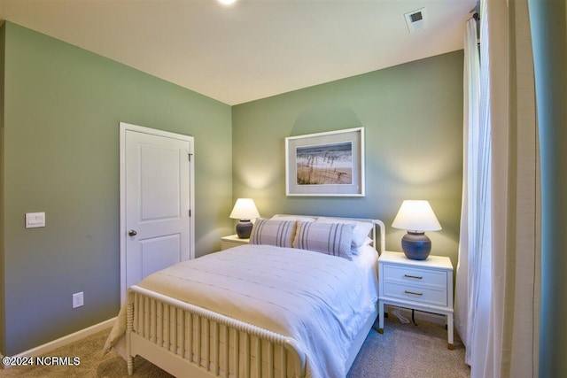 bedroom featuring light carpet