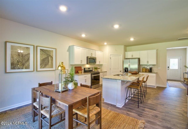 dining room featuring dark wood-type flooring and sink